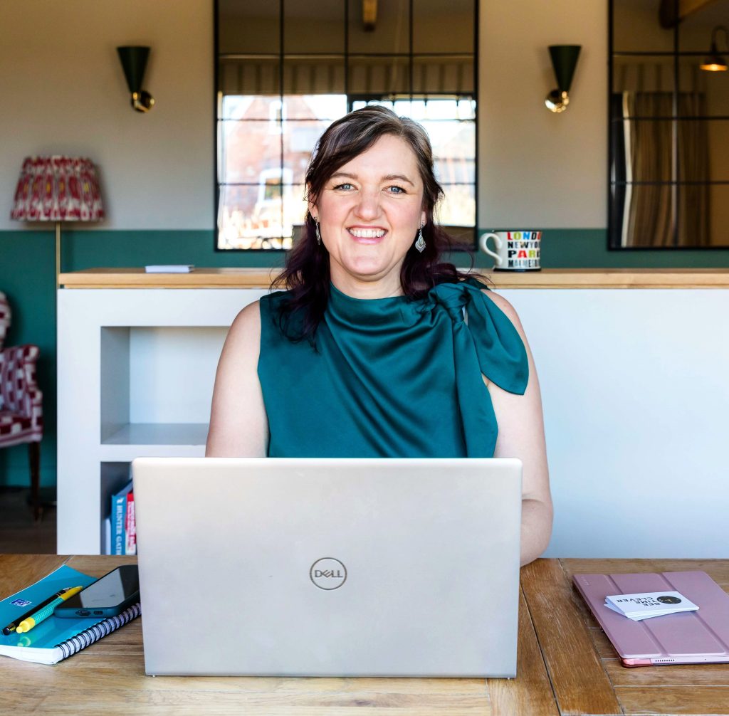 Melissa at a desk with her laptop