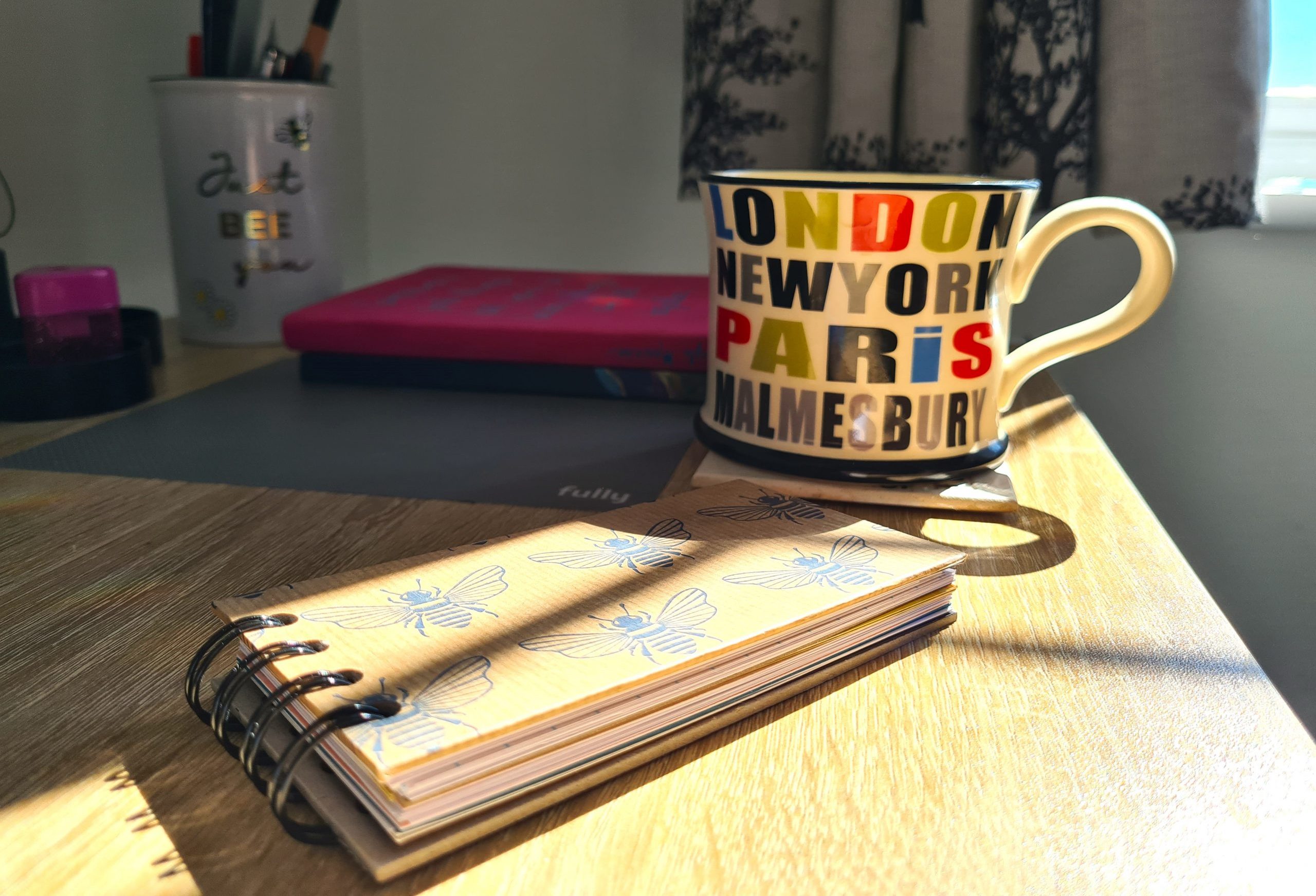 Social Media Management Wiltshire and Somerset - Cup and book on a table in sunlight