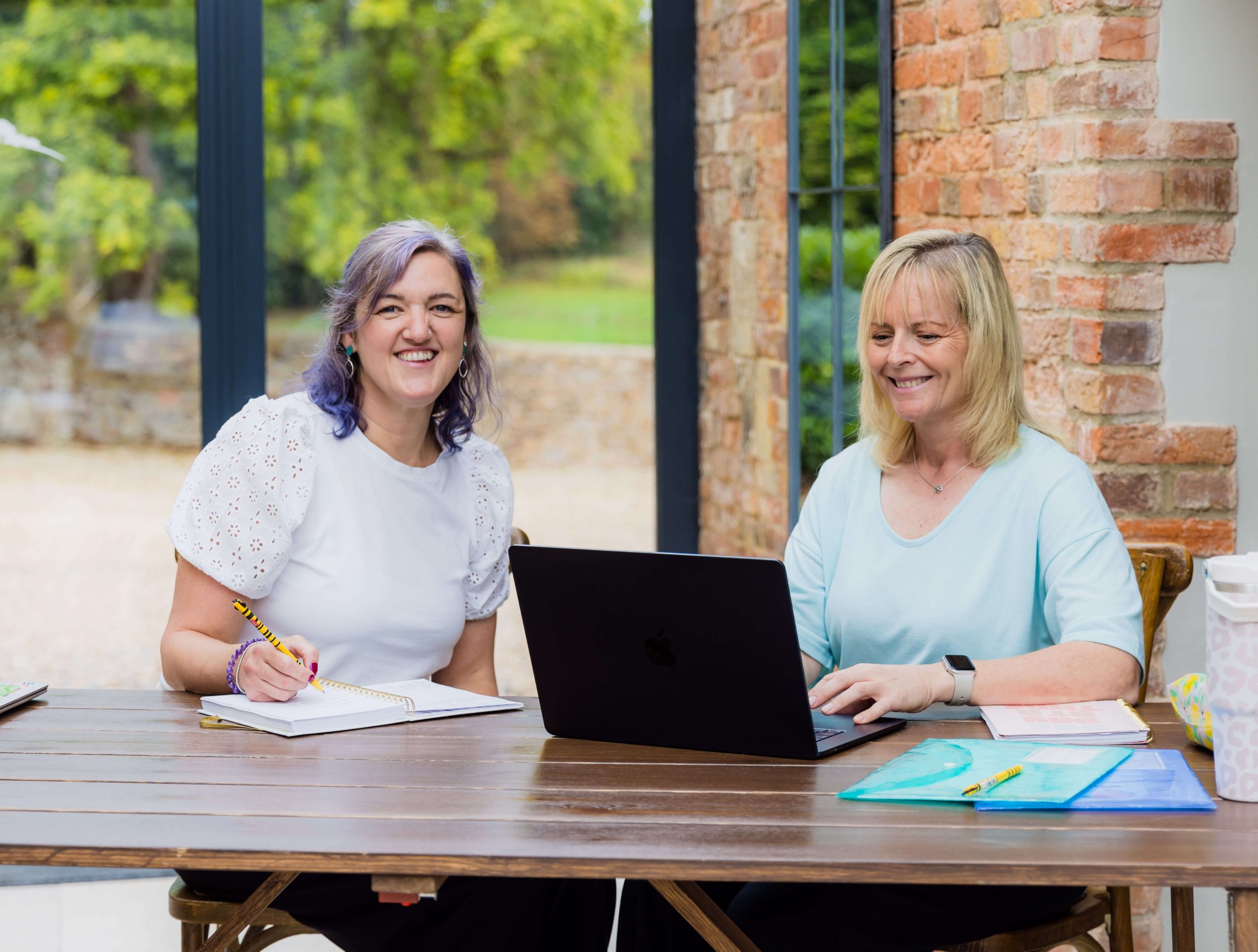 Melissa and Lisa of Bee Time Clever collaborating at a desk