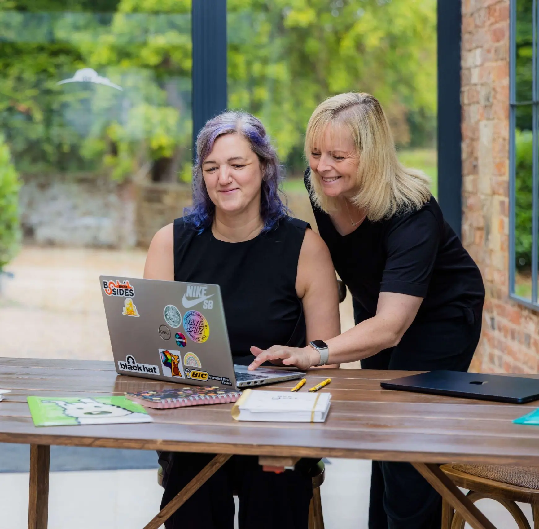 Founder and Director at a desk looking at a laptop.