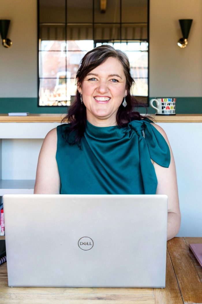 Melissa at a desk with her laptop